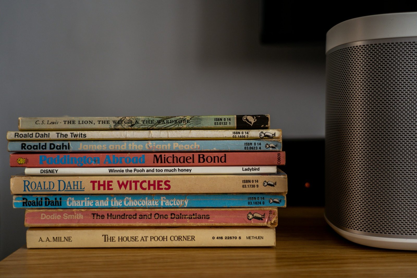 stack of books on brown wooden table