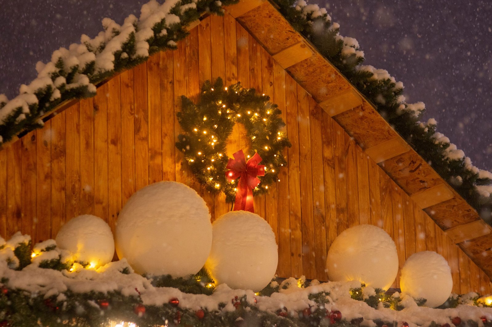 a house with a christmas wreath and lights on it